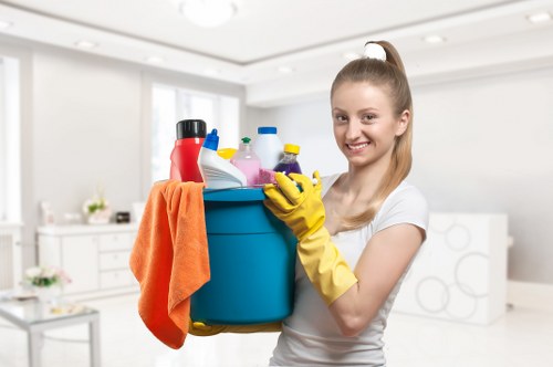 Cleaner treating a lounge sofa during upholstery cleaning in Brompton